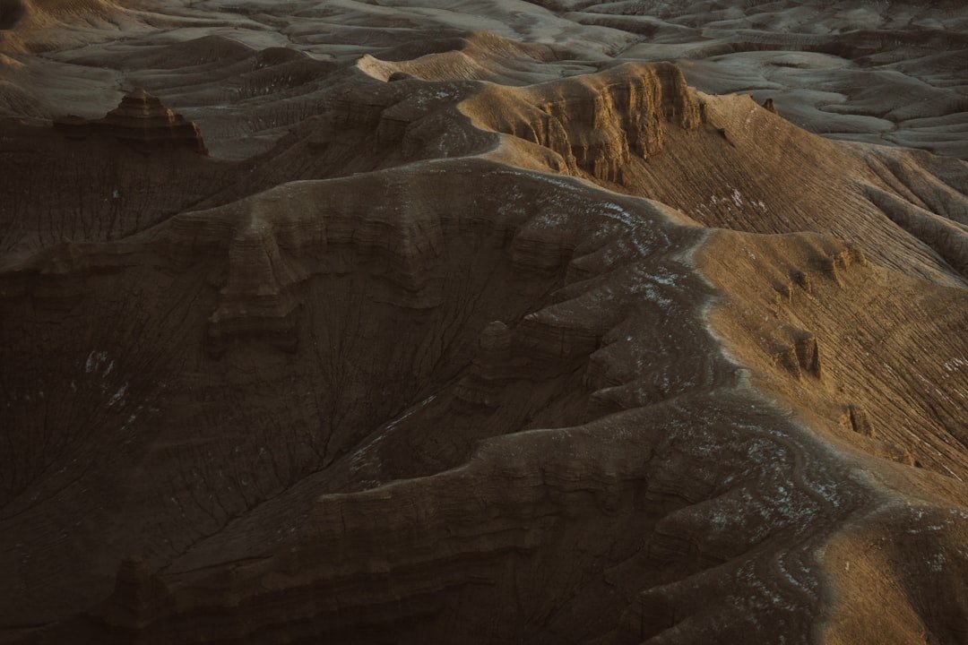 an aerial view of a mountain range at sunset