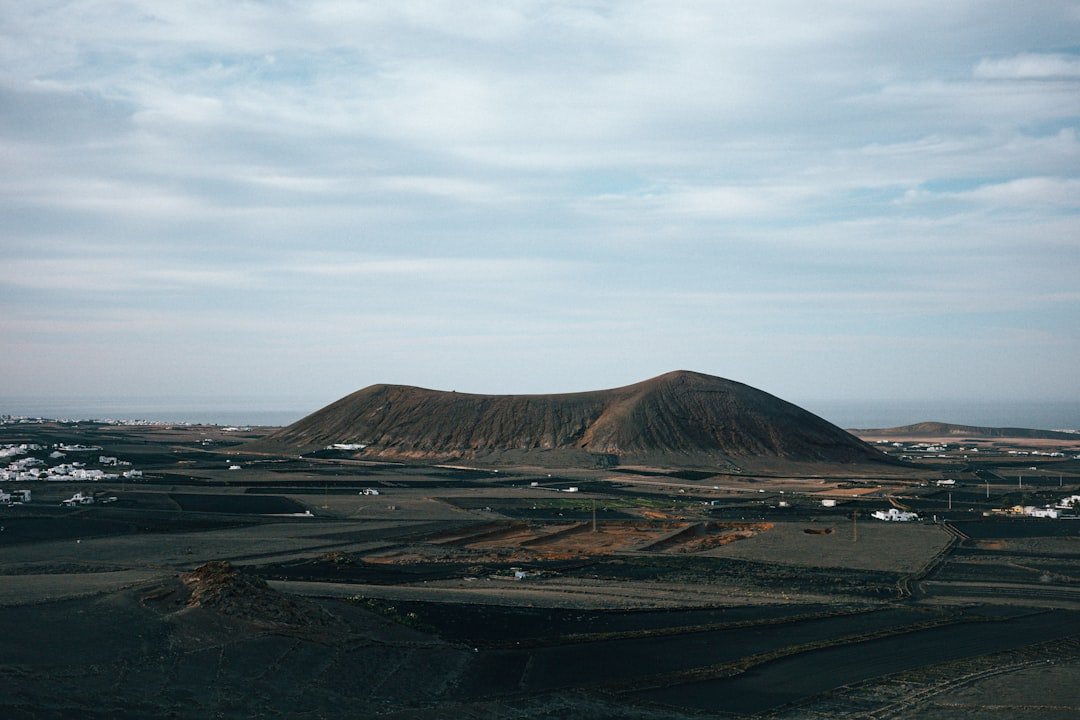 A large hill in the middle of a desert