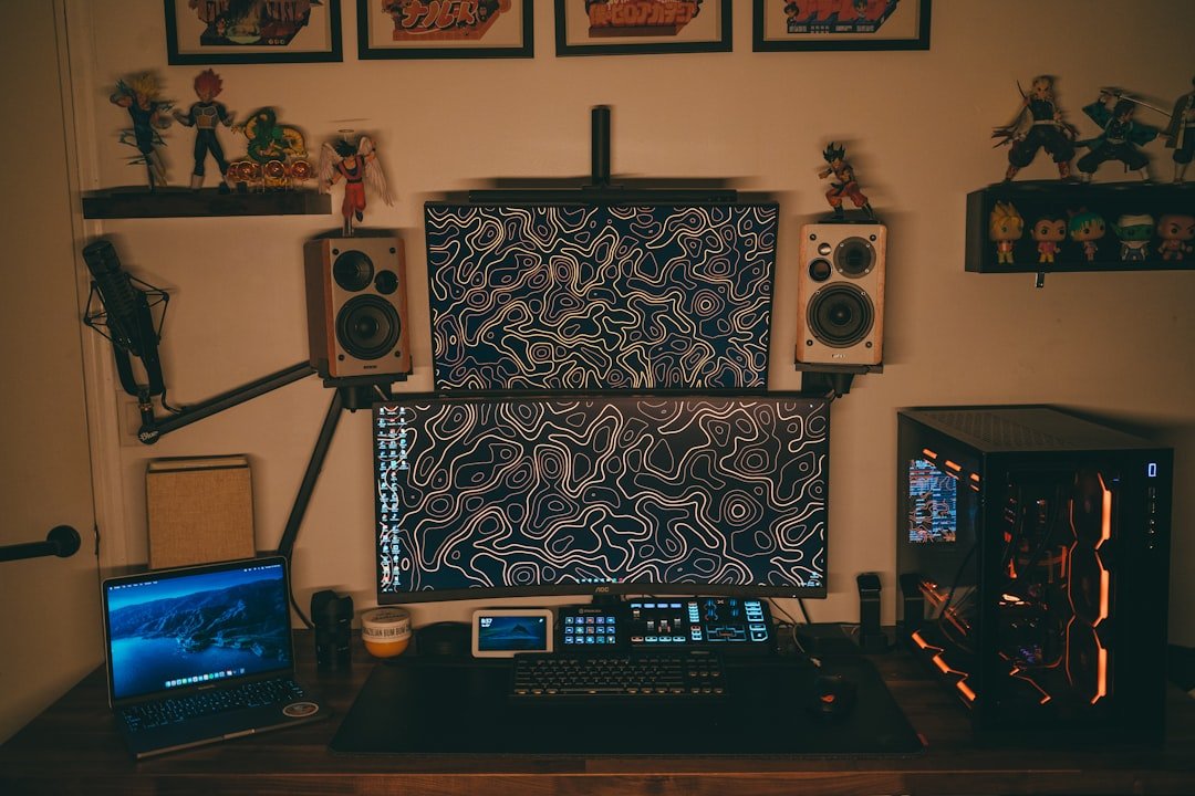 a computer desk with a laptop and speakers on it