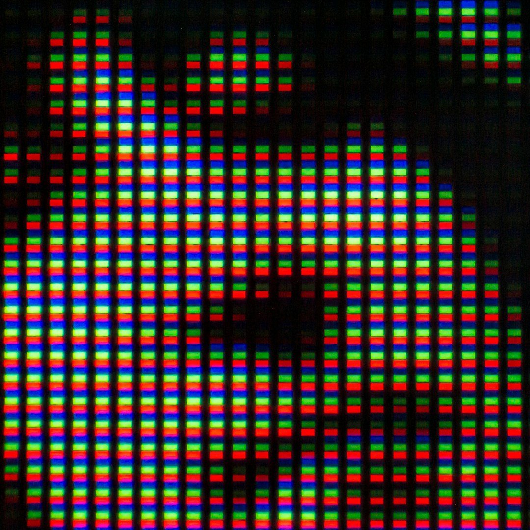 Close-up of a digital screen showing colored pixels.