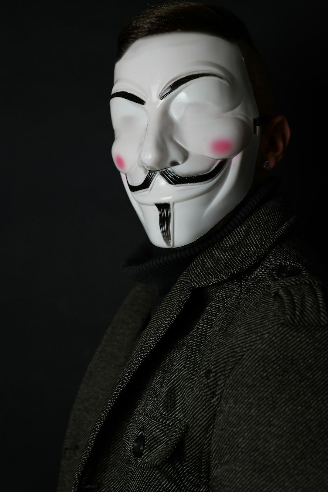 a man wearing a white mask with pink eyes