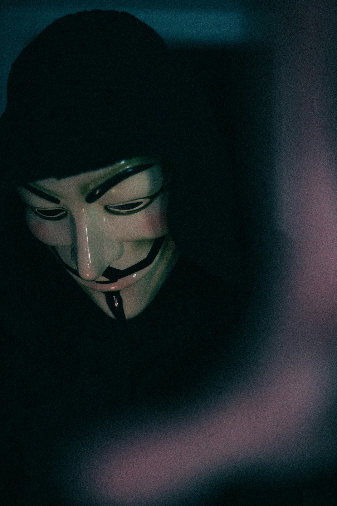 a person wearing a mask and holding a cell phone