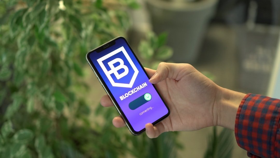 a person holding a cell phone in their hand