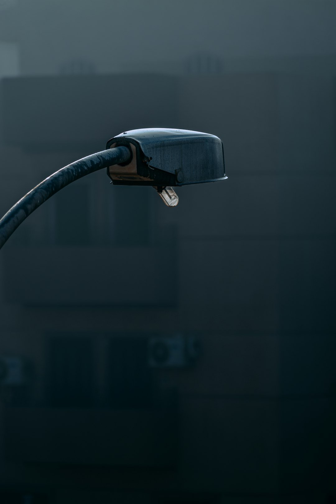 a street light with a building in the background