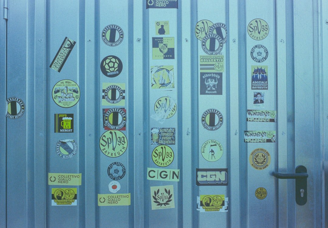 A bunch of stickers on a metal door
