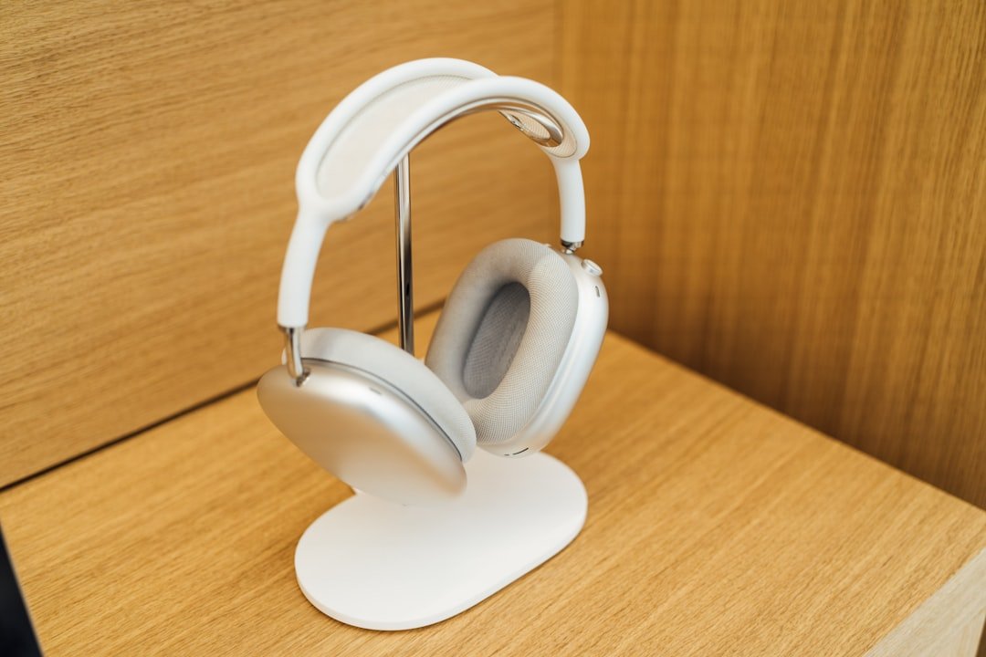 a pair of headphones sitting on top of a white stand