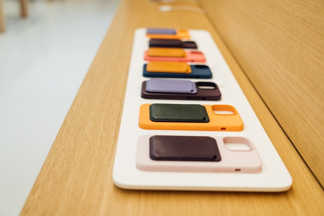 a row of cell phones sitting on top of a wooden table