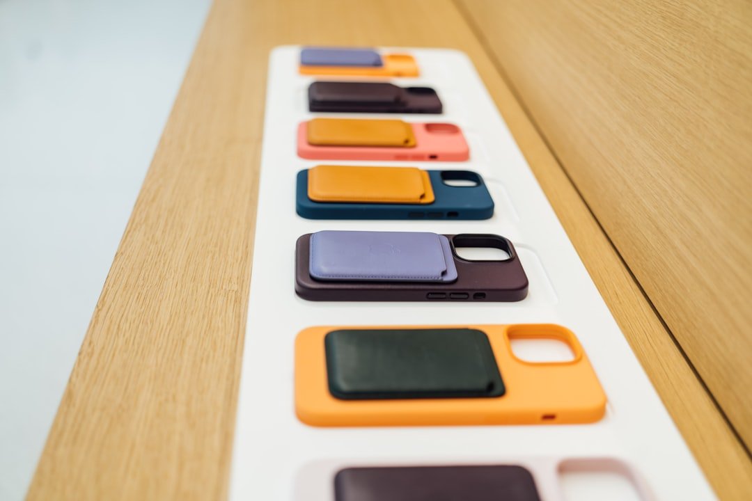 a row of cell phones sitting on top of a wooden table