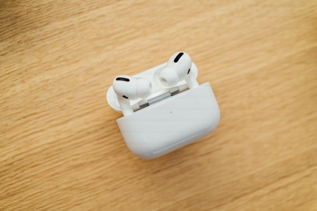 a pair of ear buds sitting on top of a wooden table