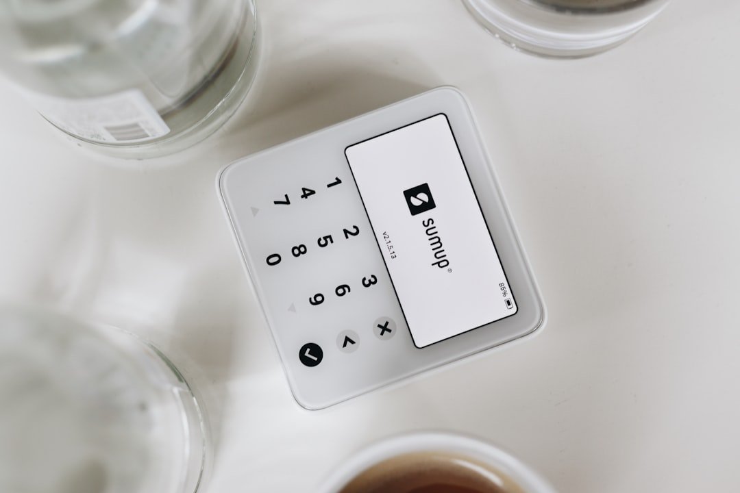 A white table topped with cups of coffee and a remote control