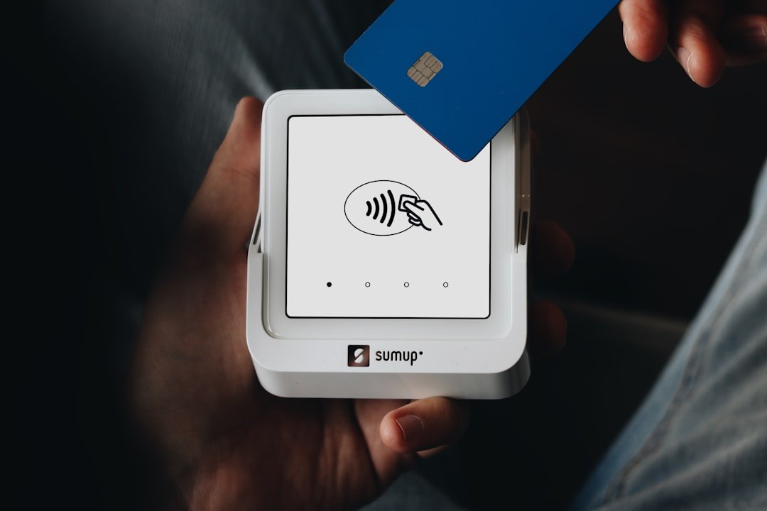A person holding a credit card in their hand