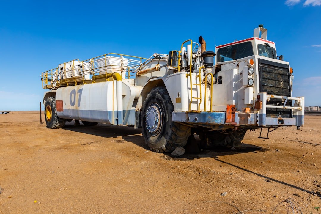 a large truck parked on top of a dirt field
