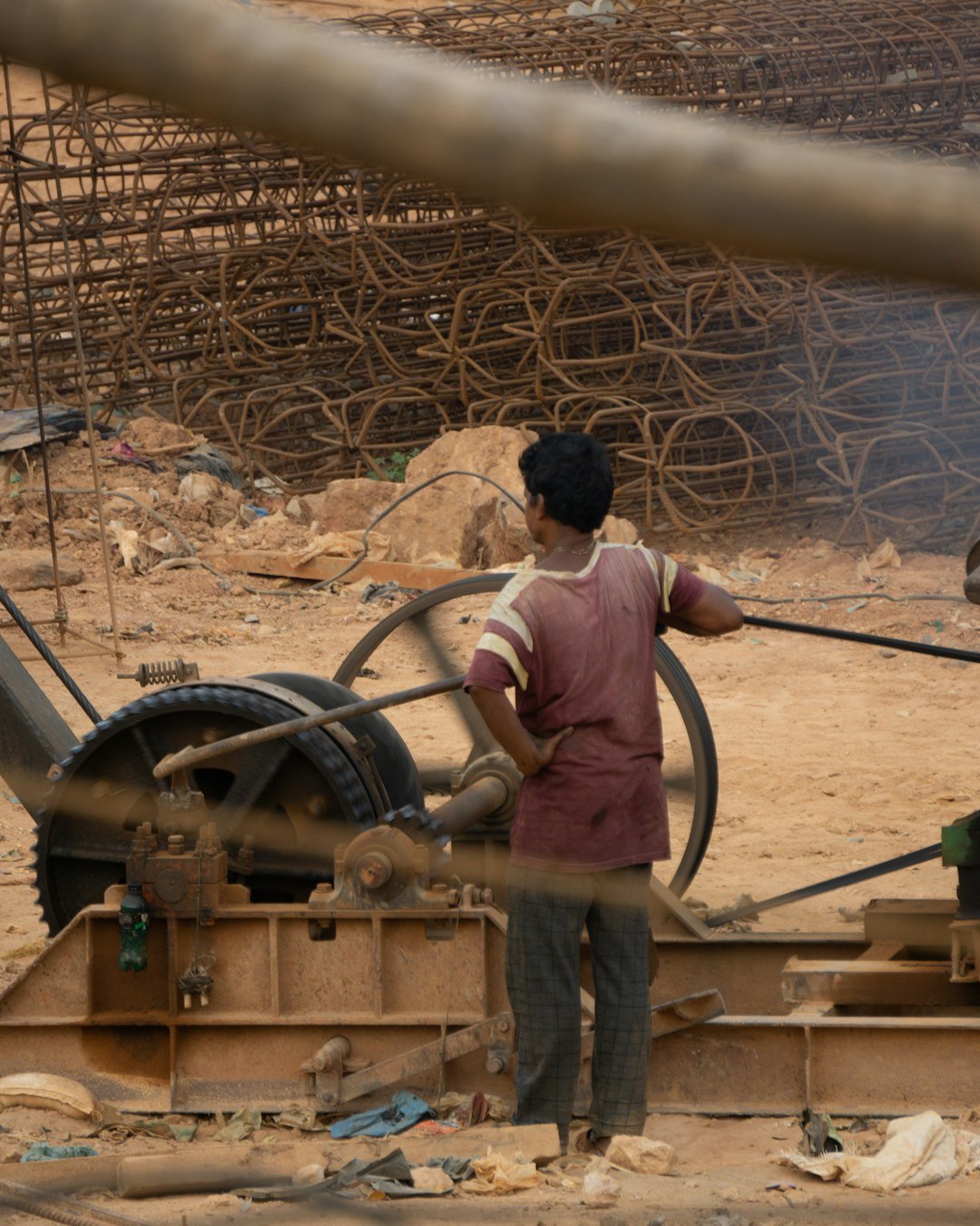 A man standing next to a machine in a construction area