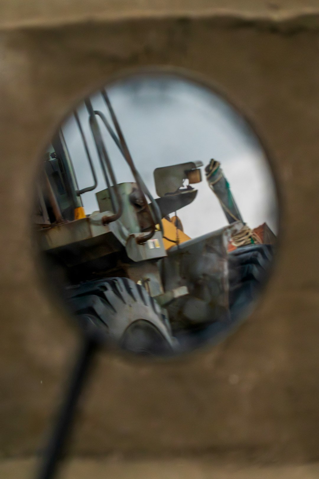 Reflection of a construction vehicle in a mirror