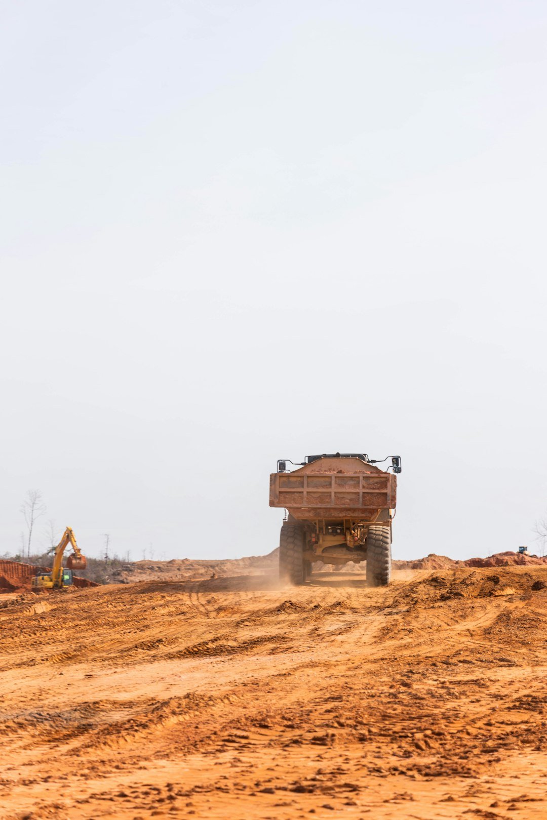 A dump truck drives on the construction site.