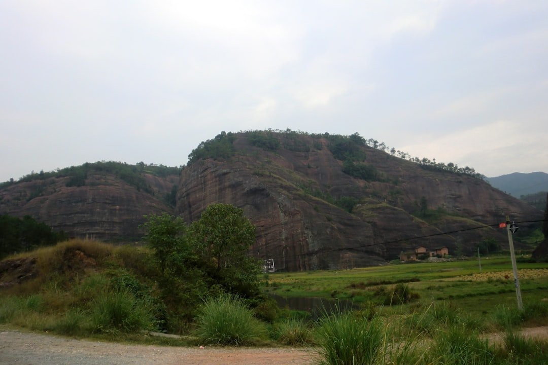 a large rock formation in the middle of a field