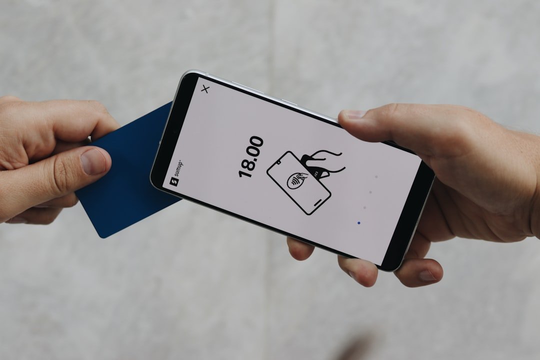 A person holding a cell phone in their hand