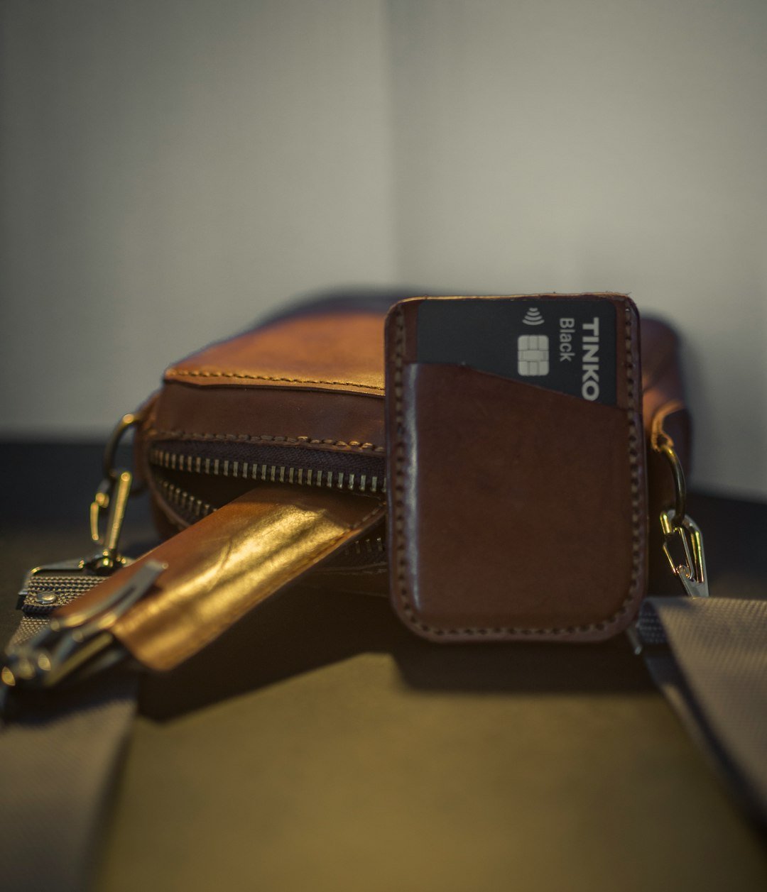 a wallet with a credit card holder on top of it