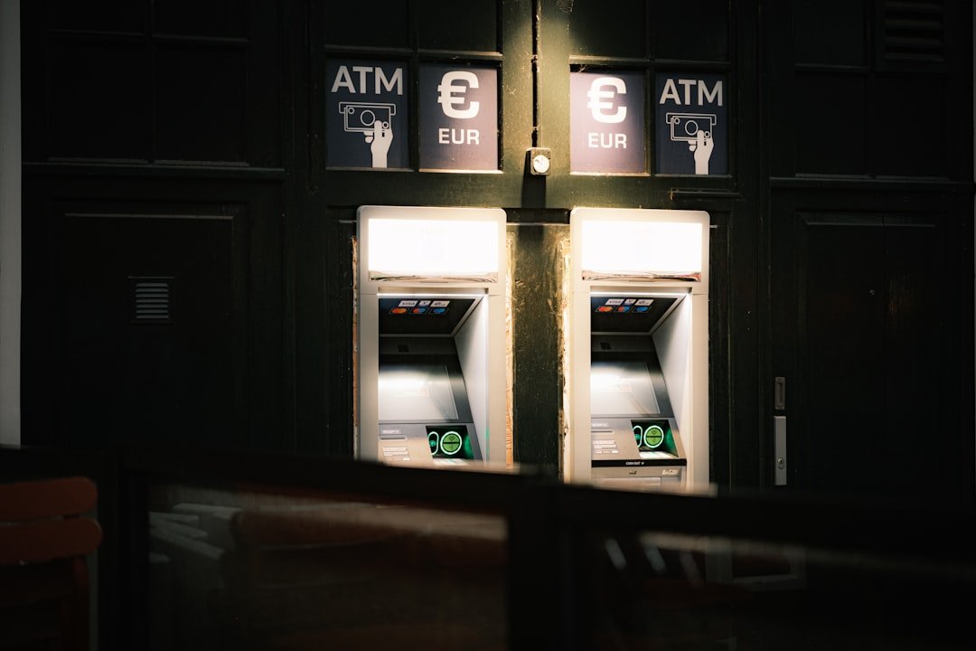 A couple of atm machines sitting next to each other