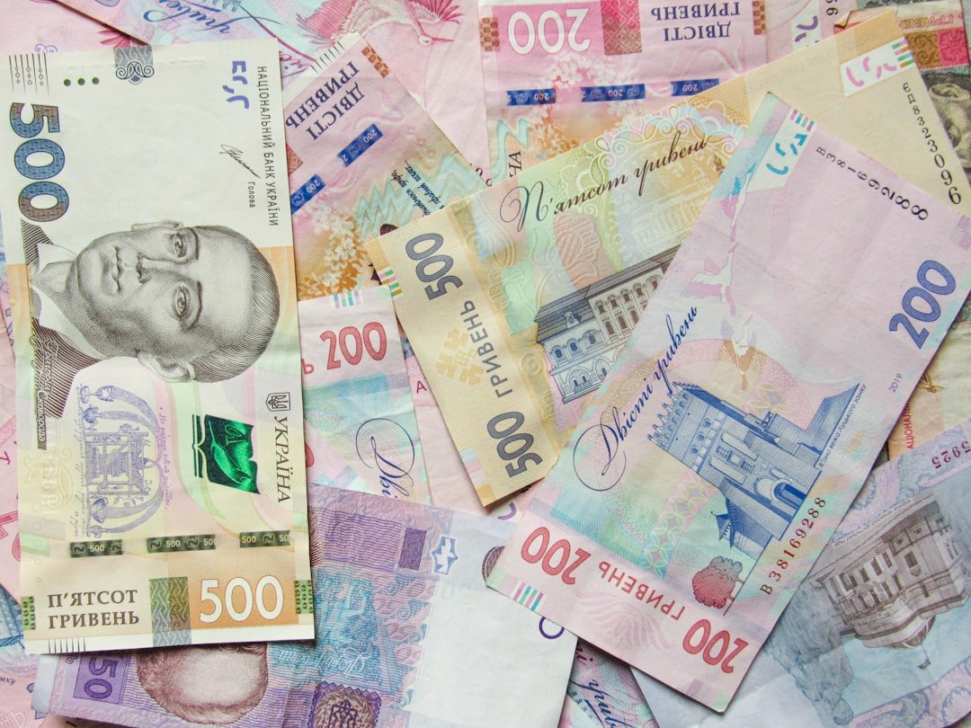 a pile of different bank notes laying on top of each other