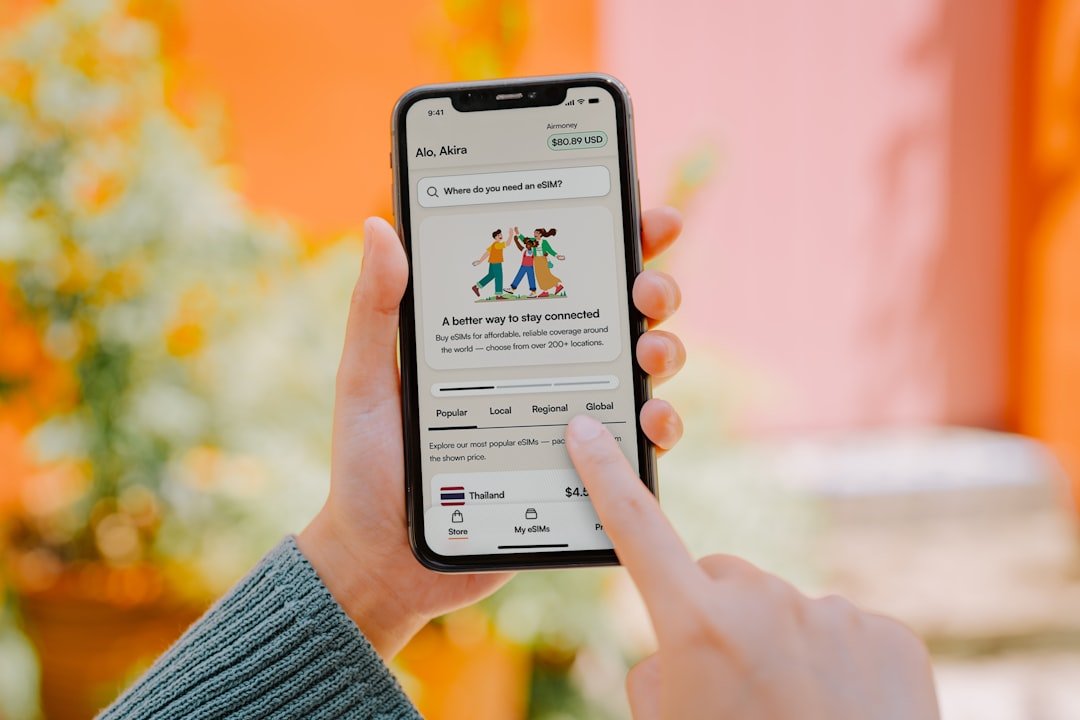 Person using a smartphone with colorful background.